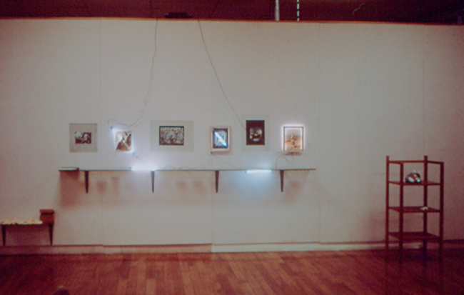 An artwork by Harry Anderson composed of Plate glass, photographs and neon