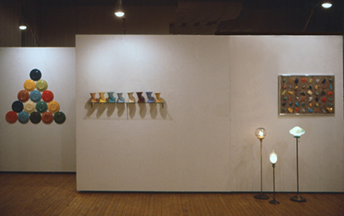Installation photograph of Harry Anderson's exhibit at Swarthmore College showing lamps, installations from found objects and fiesta ware and a wall work created from linoleum and broken pottery.